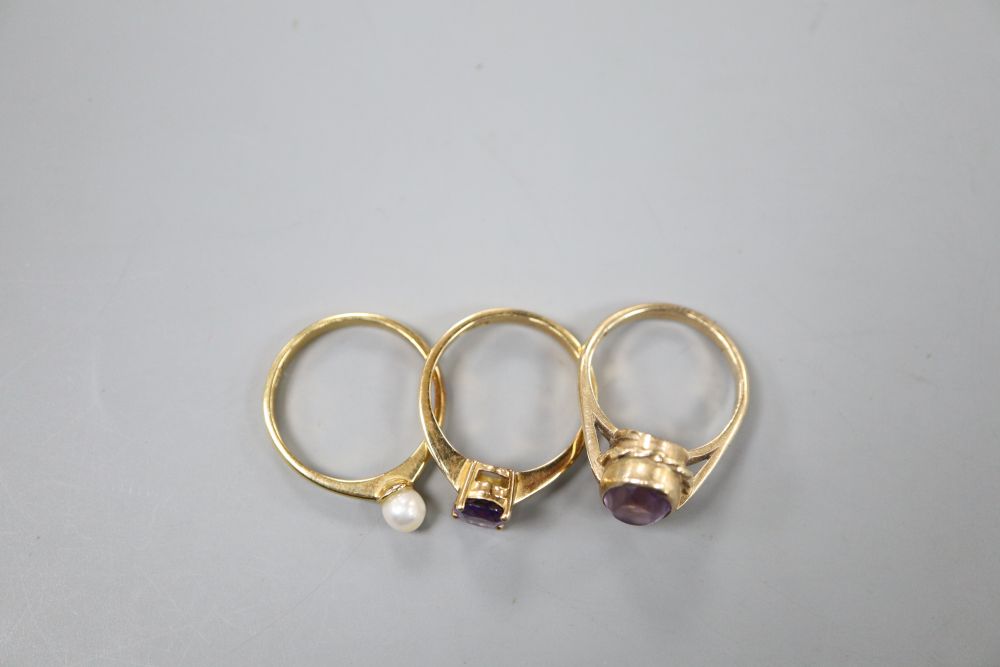 An 18ct gold and pearl ring, a pale amethyst and 9ct gold ring and an amethyst and 18ct gold ring (3)